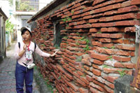 Photo of girl and brick wall